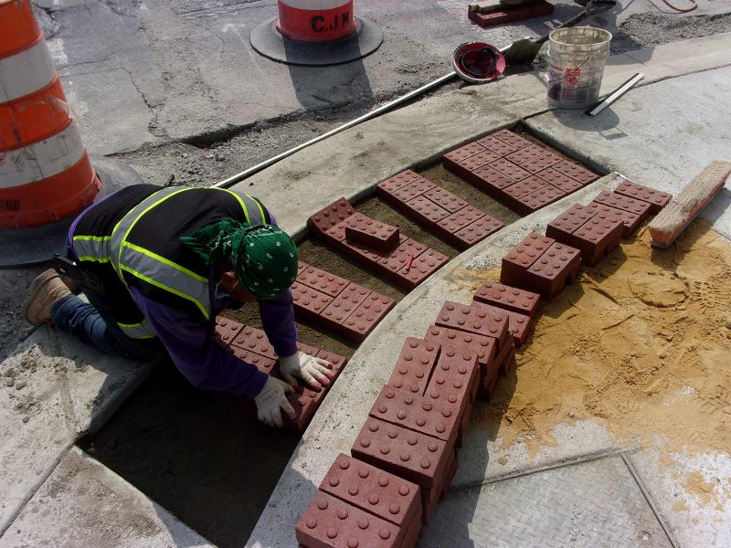 Construction worker laying bricks on MD 30 Business