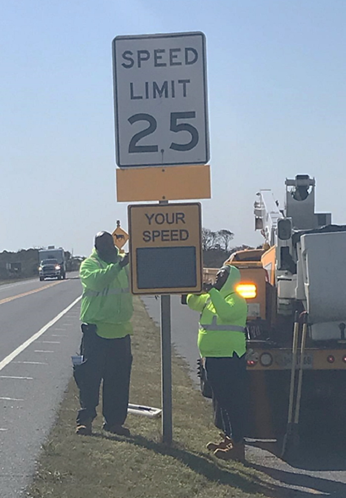 SHA photo: Crews install a new sign on MD 611 (Stephen Decatur Highway) at the entrance to Assateague Island, Worcester County