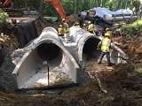 Roadworkers replacing culvert
