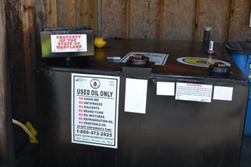 sign on desk about proper disposal of vehicle fluids